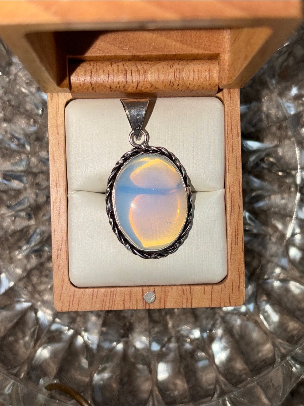 Opalite Oval Pendant Necklace with a twisted frame Stamped 925 sterling silver.